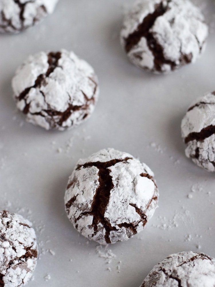 Classic holiday Chocolate Crinkle Cookies with a twist! Made with coconut oil and Abuelita Mexican chocolate, these festive cookies are soft, chewy and covered in powdered sugar.