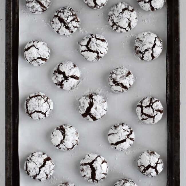 Classic holiday Chocolate Crinkle Cookies with a twist! Made with Abuelita Mexican chocolate, these festive cookies are soft, chewy and covered in powdered sugar.