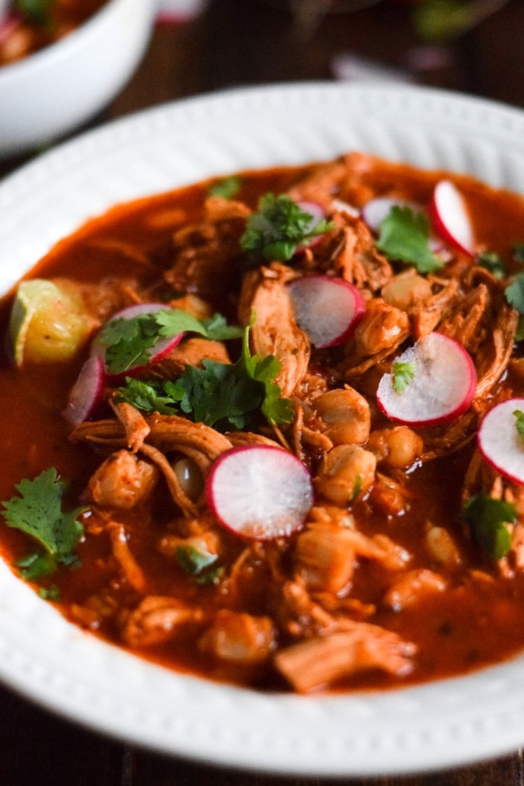 Made with shredded chicken and hominy in a comforting red chile broth, this Slow Cooker Chicken Posole is easy to make and full of authentic Mexican flavors.