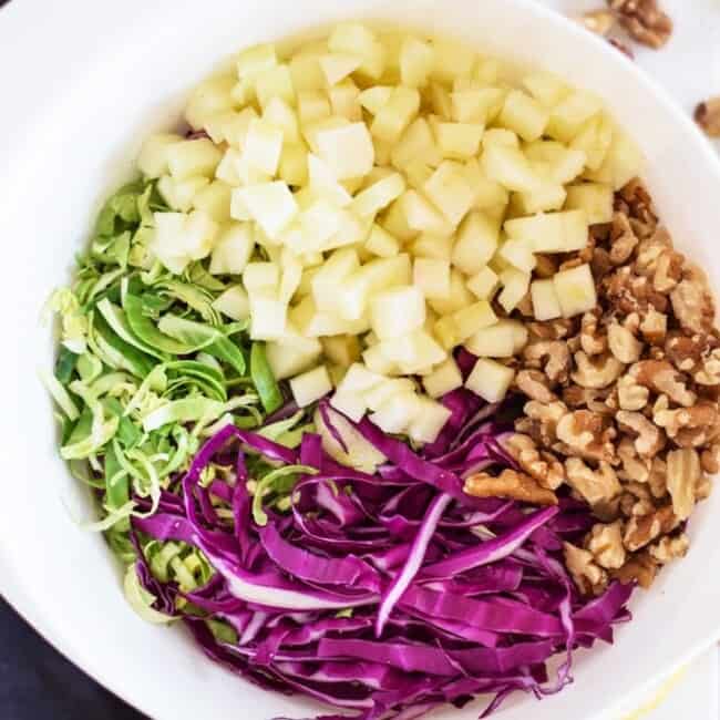 This healthy Brussels Sprouts Slaw with Cabbage and Apples is the perfect side dish for any meal. Also goes great on tacos! (gluten free, paleo, vegetarian, vegan)