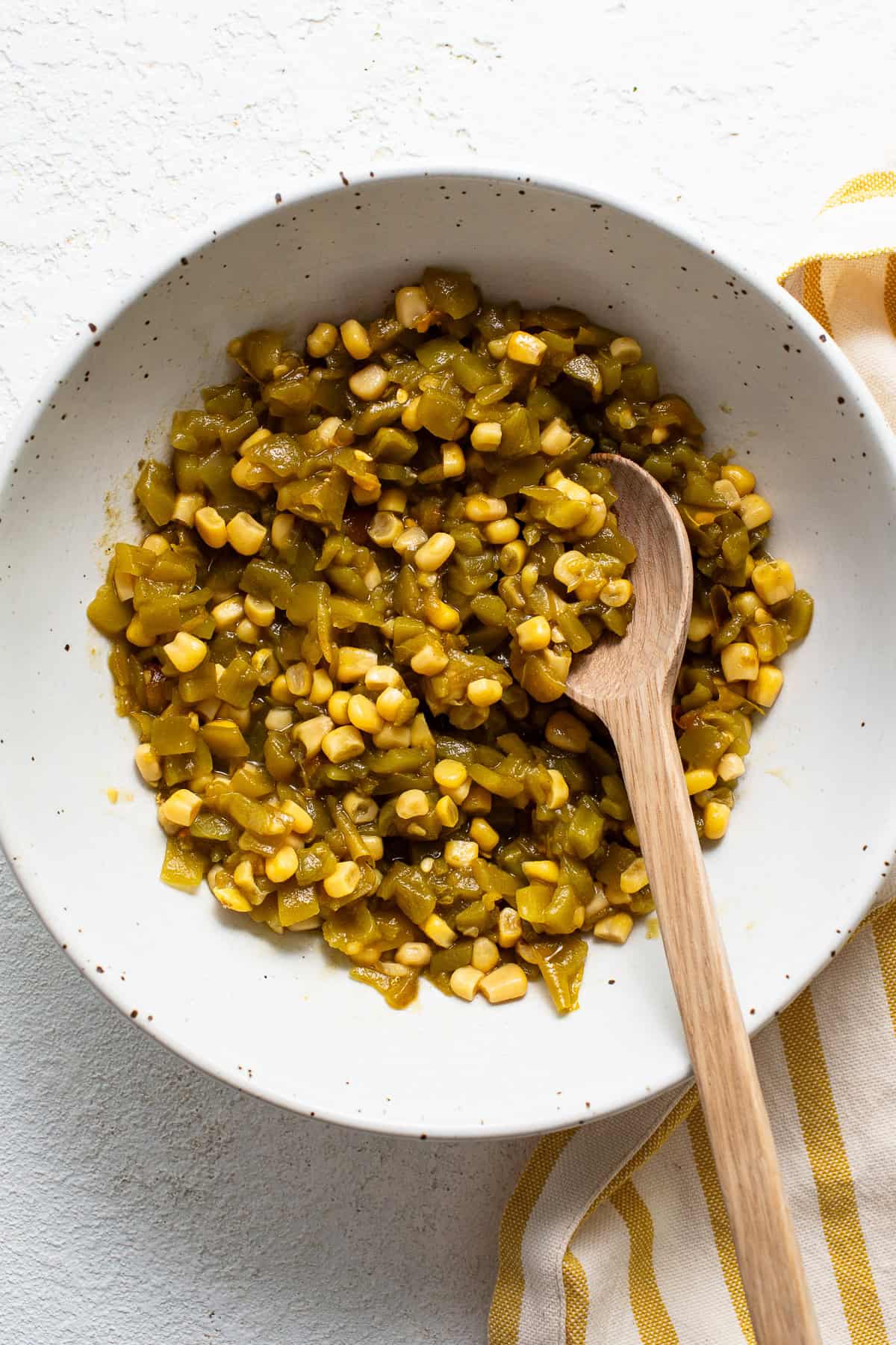 A bowl of corn and diced green chiles.