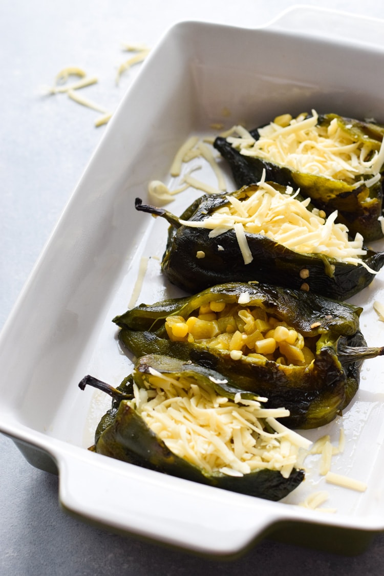 Roasted poblano peppers stuffed with cheese for chile rellenos.