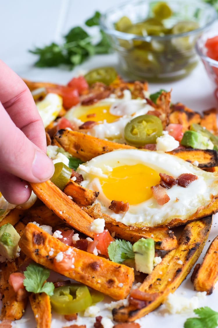 Baked Loaded Sweet Potato Breakfast Fries topped with sunny side up eggs, bacon, avocados and cotija cheese are sure to be your new favorite weekend breakfast.