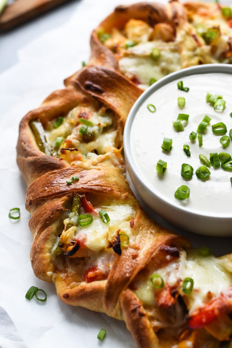 This easy Buffalo Chicken Fajita Pizza Ring is the perfect game day appetizer for parties and get-togethers. By the end of the night, everyone will be asking for the recipe!