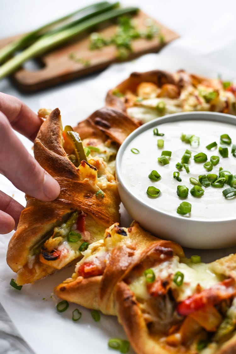 This easy Buffalo Chicken Fajita Pizza Ring is the perfect game day appetizer for parties and get-togethers. By the end of the night, everyone will be asking for the recipe!