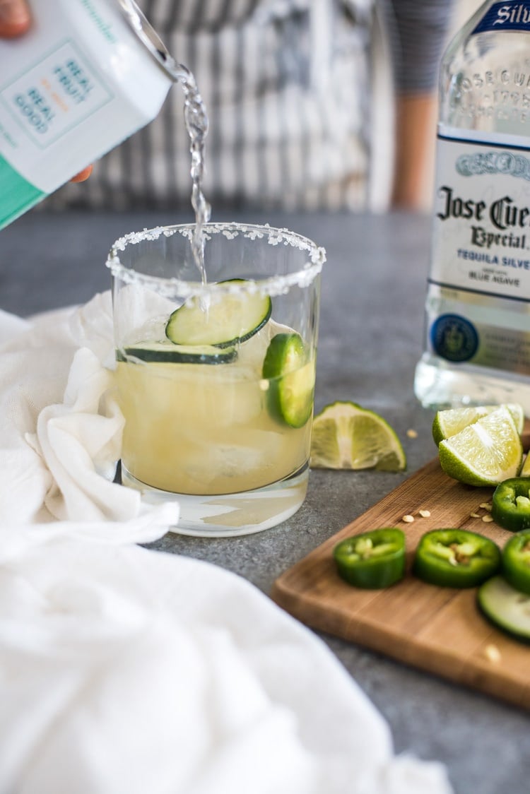 A Cucumber Jalapeno Margarita made with refreshing cucumber sparkling water, fresh jalapeños and organic agave nectar because it's 5 o'clock somewhere!