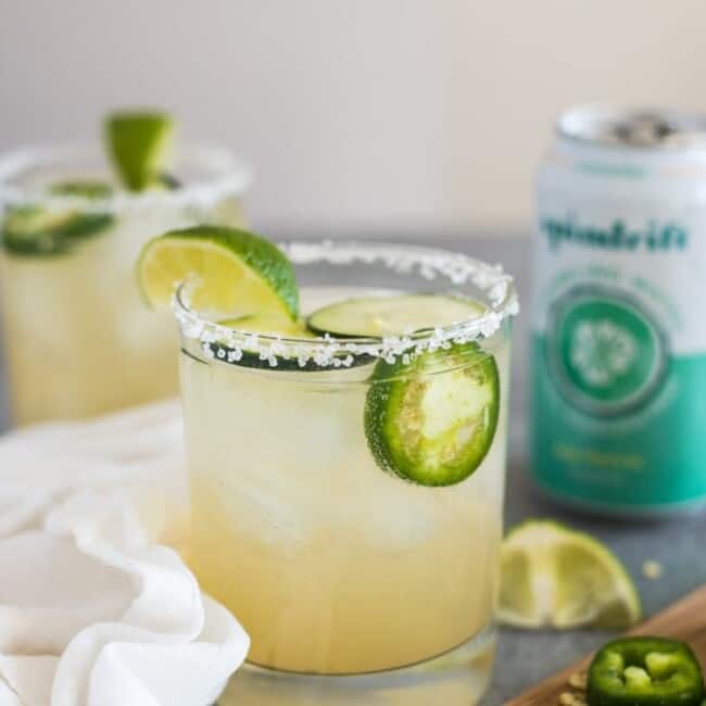 A Cucumber Jalapeno Margarita made with refreshing cucumber sparkling water, fresh jalapeños and organic agave nectar because it's 5 o'clock somewhere!