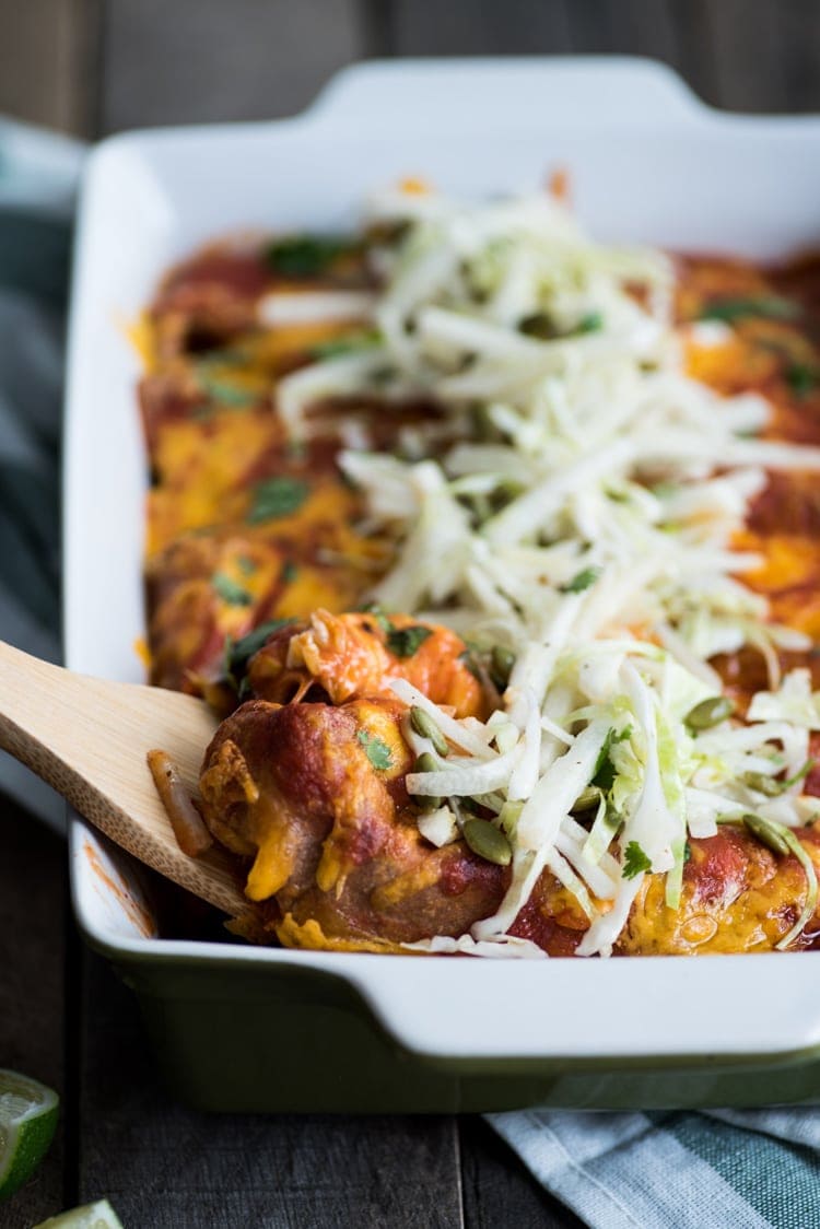 Covered in a red enchilada sauce, these Mexican Ground Beef Enchiladas with Lime Jicama Slaw are great for dinner and make tasty leftovers that everyone will be excited to eat!