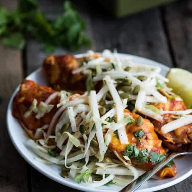 Covered in a red enchilada sauce, these Mexican Ground Beef Enchiladas with Lime Jicama Slaw are great for dinner and make tasty leftovers that everyone will be excited to eat!