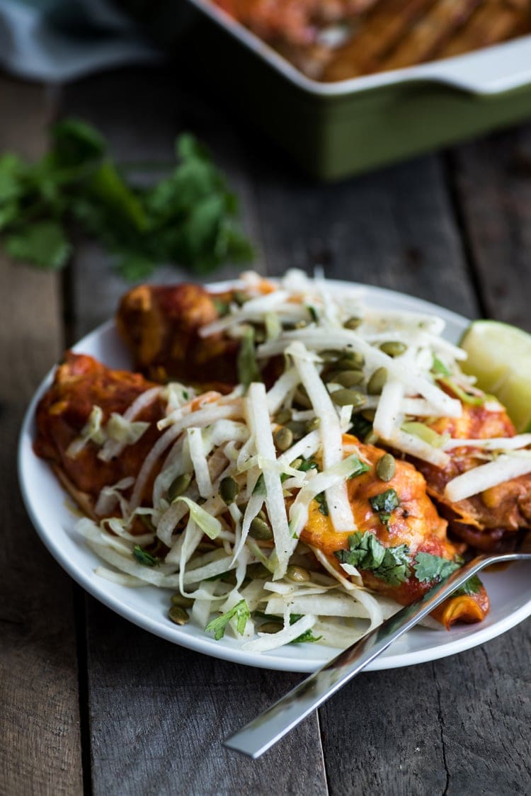 Covered in a red enchilada sauce, these Mexican Ground Beef Enchiladas with Lime Jicama Slaw are great for dinner and make tasty leftovers that everyone will be excited to eat!