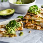 Seasoned with honey, garlic, lime juice and jalapeños, this Jalapeño Chicken Quesadilla topped with Honey Guacamole takes lunchtime to a whole new level.