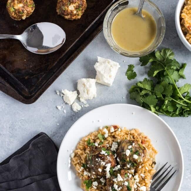 These Mexican Turkey Meatballs made with cilantro, garlic and a packet of taco seasoning are a great appetizer or weeknight meal when served with Arroz Verde.