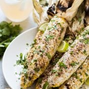 Authentic Mexican Street Corn on the cob covered in creamy mayo and topped with cilantro, lime juice, Cotija cheese and chili powder is the perfect Mexican summer side dish!
