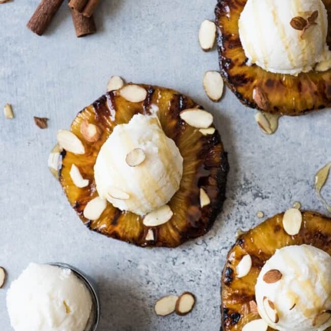 This No Churn Coconut Ice Cream is smooth, creamy and made with only 2 ingredients! Served with ponche roasted pineapples, it's perfect for hot summer days.