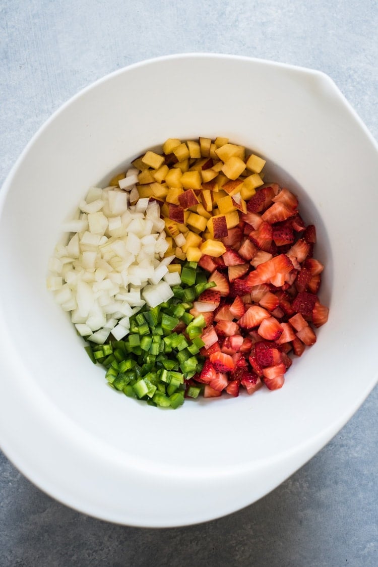 This Peach Strawberry Salsa is super fresh, sweet yet savory and tastes great with chips and salsa. Also makes a great topping for tacos, salads and grilled meats! 