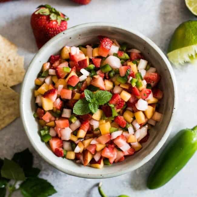 This Peach Strawberry Salsa is super fresh, sweet yet savory and tastes great with chips and salsa. Also makes a great topping for tacos, salads and grilled meats! 