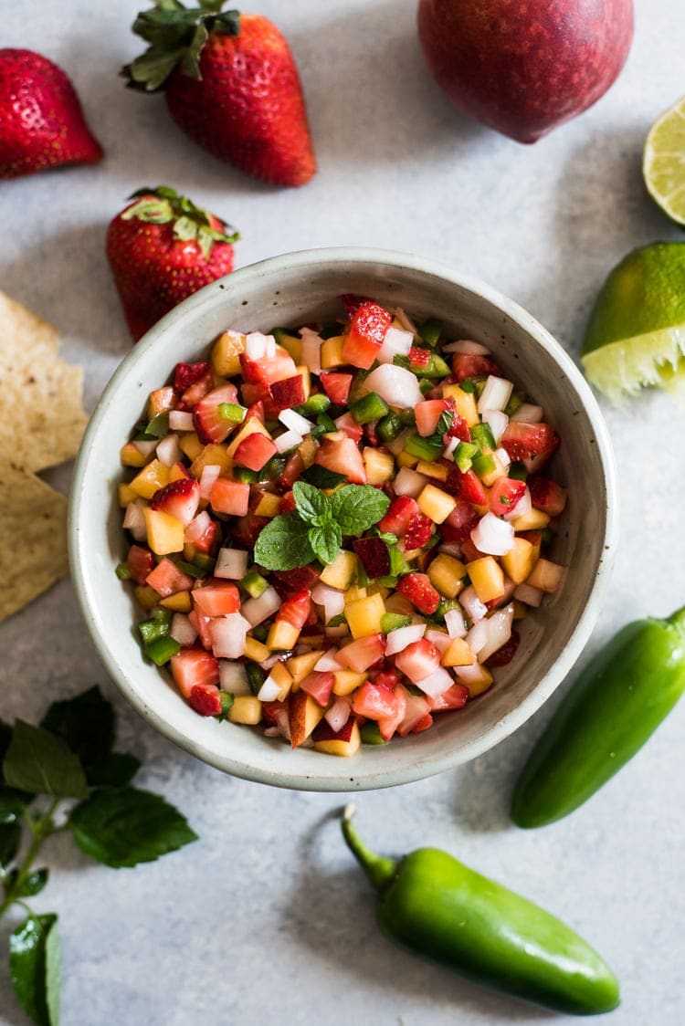 This Peach Strawberry Salsa is super fresh, sweet yet savory and tastes great with chips and salsa. Also makes a great topping for tacos, salads and grilled meats! 