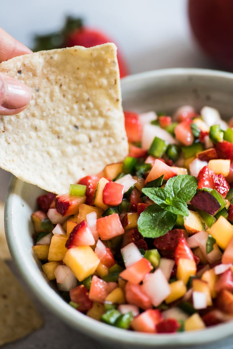 This Peach Strawberry Salsa is super fresh, sweet yet savory and tastes great with chips and salsa. Also makes a great topping for tacos, salads and grilled meats! 