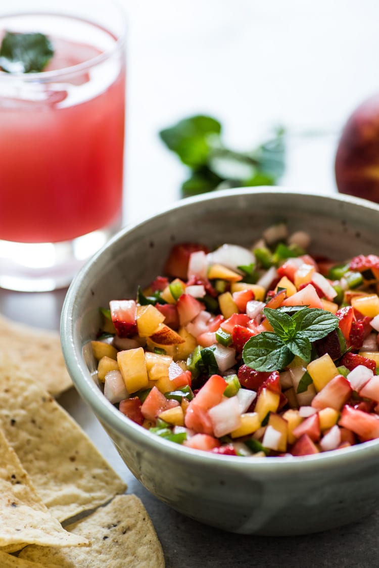 This Peach Strawberry Salsa is super fresh, sweet yet savory and tastes great with chips and salsa. Also makes a great topping for tacos, salads and grilled meats! 