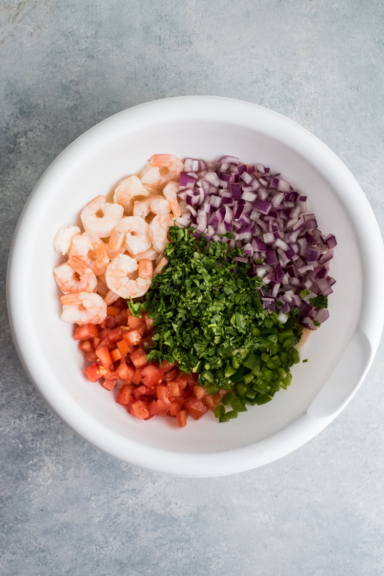 This easy, light and refreshing Mexican Ceviche Rice Bowl is the perfect summer meal made from citrus marinated shrimp, tomatoes, onions, jalapenos and cilantro.