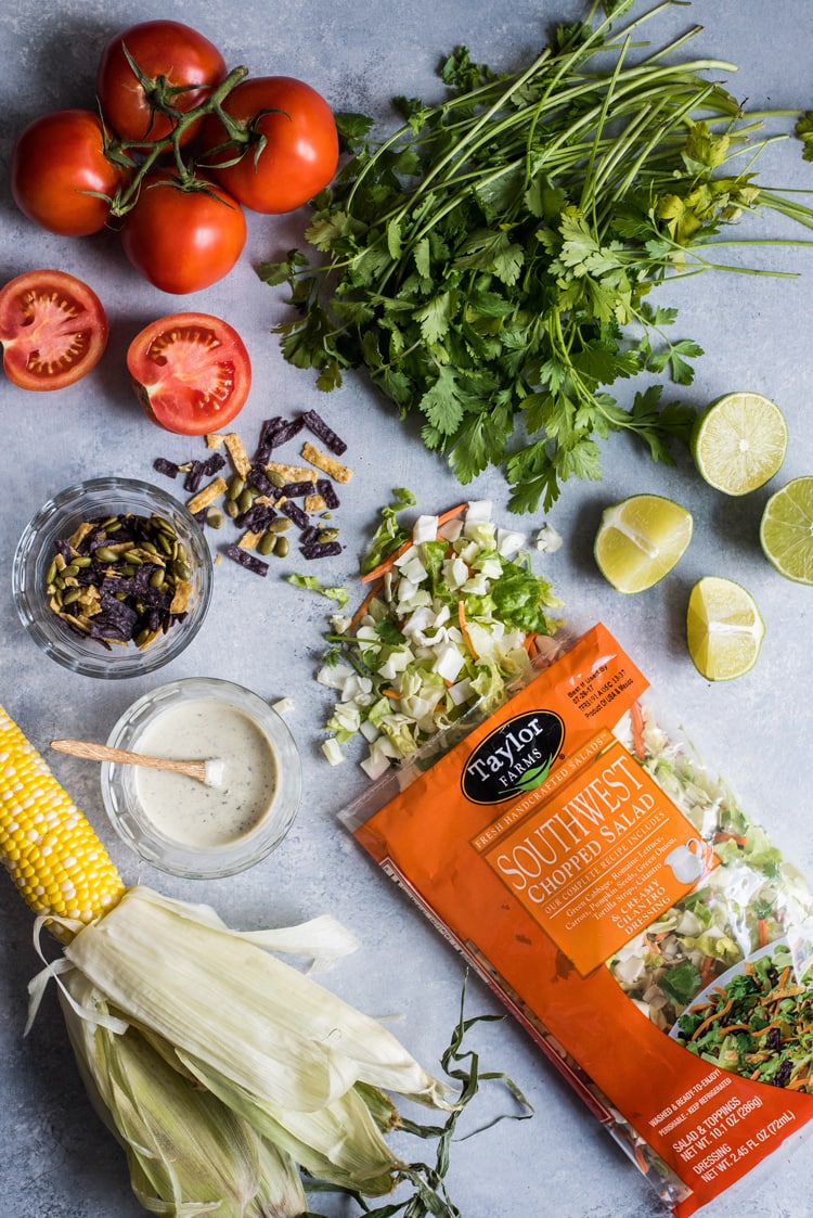 A bright, fresh Mexican Chimichurri Chicken Salad featuring grilled corn, summer tomatoes, marinated and grilled chimichurri chicken and creamy avocados. (gluten free)