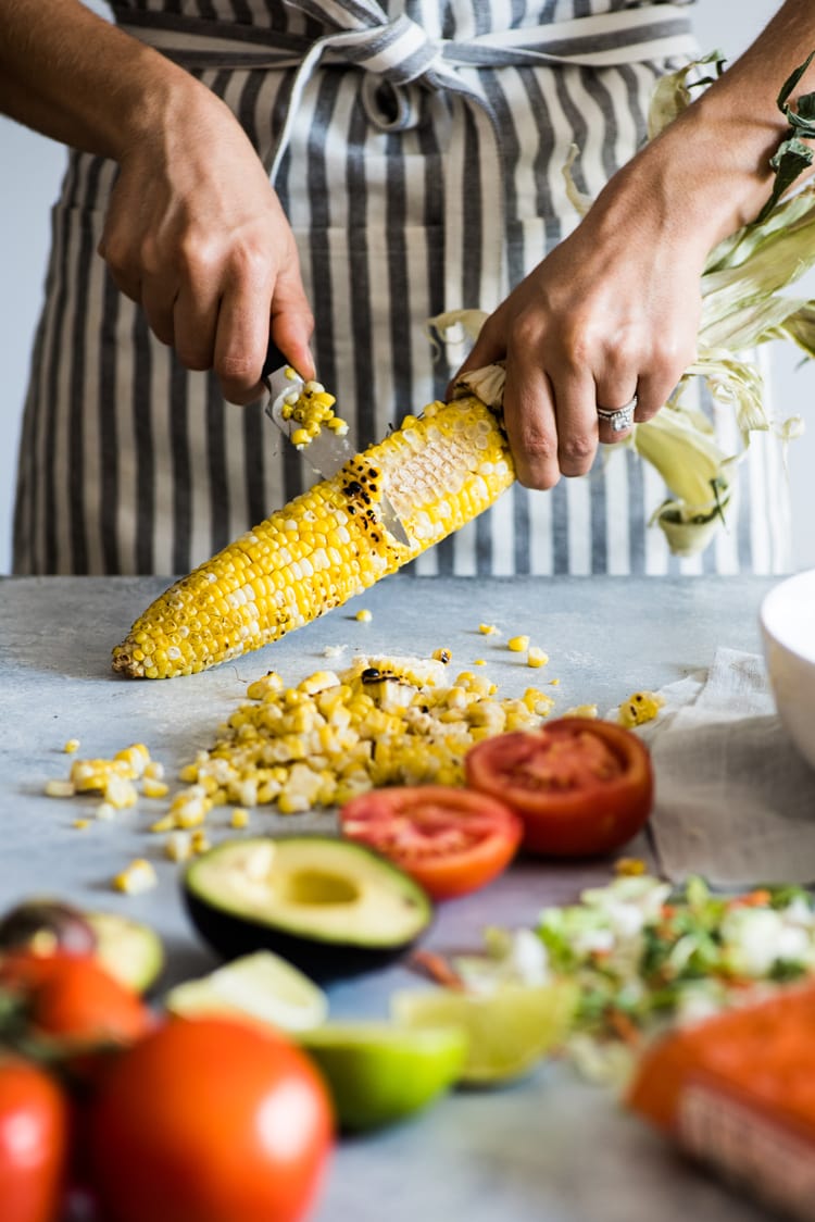 A bright, fresh Mexican Chimichurri Chicken Salad featuring grilled corn, summer tomatoes, marinated and grilled chimichurri chicken and creamy avocados. (gluten free)