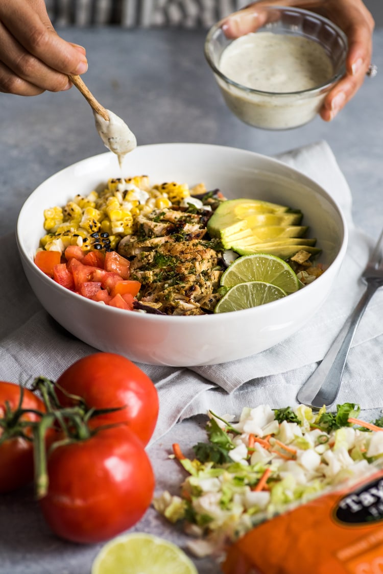 A bright, fresh Mexican Chimichurri Chicken Salad featuring grilled corn, summer tomatoes, marinated and grilled chimichurri chicken and creamy avocados. (gluten free)