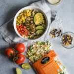 A bright, fresh Mexican Chimichurri Chicken Salad featuring grilled corn, summer tomatoes, marinated and grilled chimichurri chicken and creamy avocados. (gluten free)
