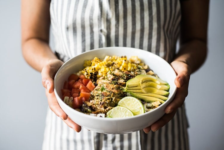 A bright, fresh Mexican Chimichurri Chicken Salad featuring grilled corn, summer tomatoes, marinated and grilled chimichurri chicken and creamy avocados. (gluten free)