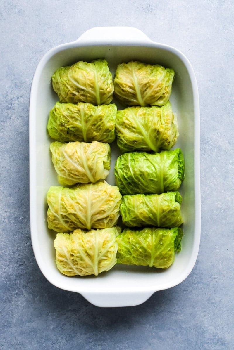 These Low Carb Enchilada Cabbage Rolls are made with cabbage leaves and stuffed with chicken, cheese and green chiles for a healthy weeknight meal!