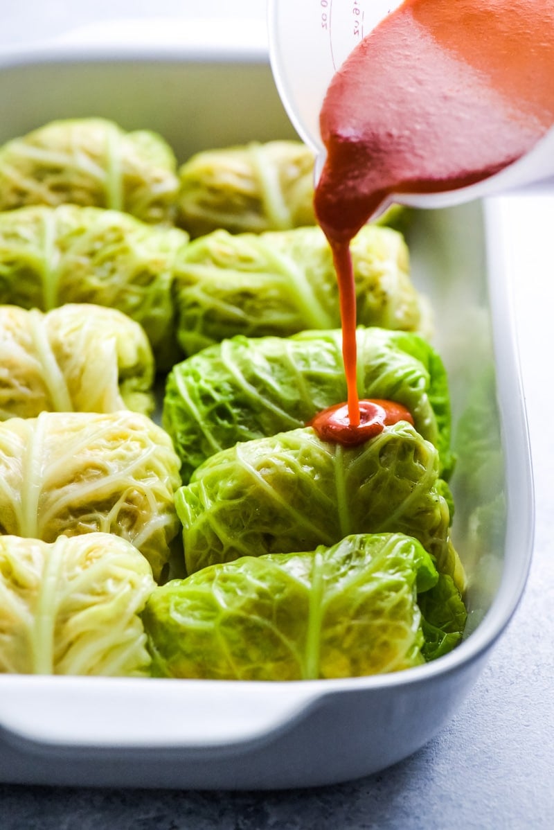 These Low Carb Enchilada Cabbage Rolls are made with cabbage leaves and stuffed with chicken, cheese and green chiles for a healthy weeknight meal!