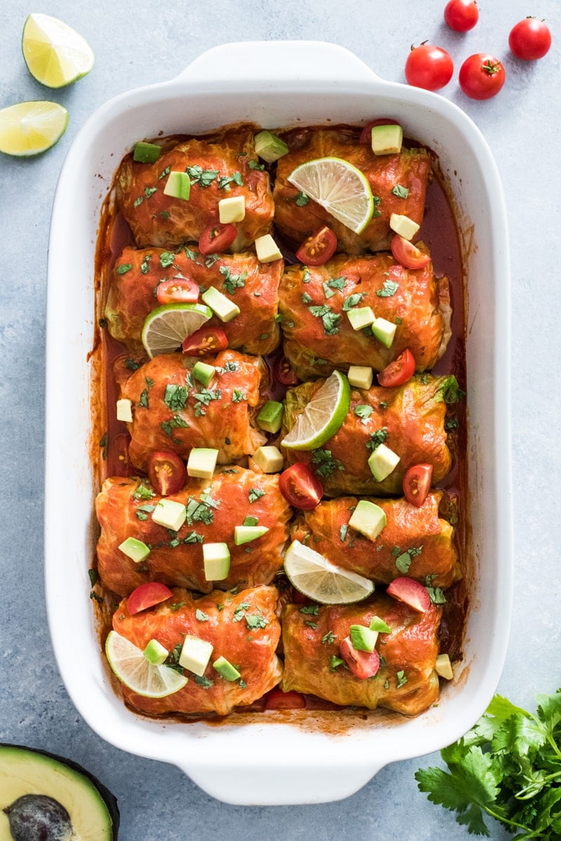 These Low Carb Enchilada Cabbage Rolls are made with cabbage leaves and stuffed with chicken, cheese and green chiles for a healthy weeknight meal!