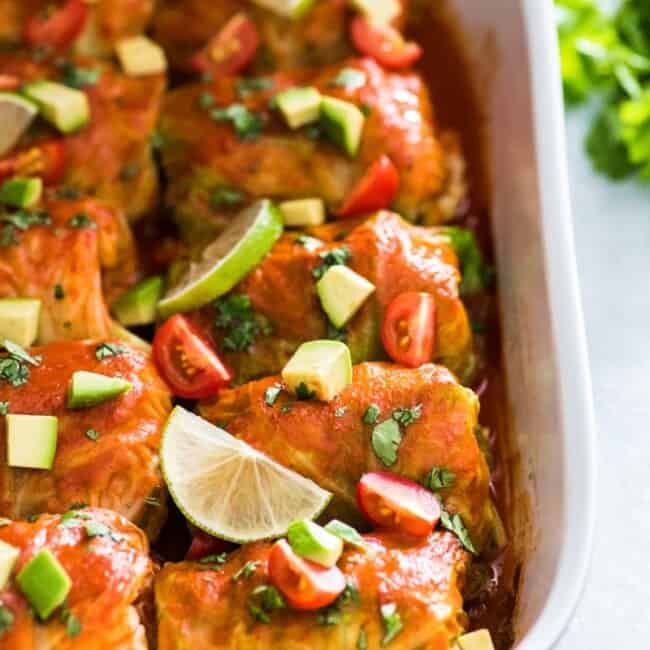 These Low Carb Enchilada Cabbage Rolls are made with cabbage leaves and stuffed with chicken, cheese and green chiles for a healthy weeknight meal!