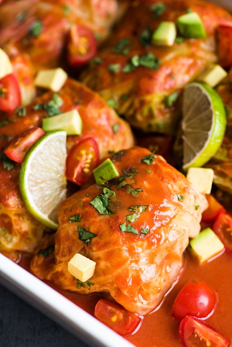 These Low Carb Enchilada Cabbage Rolls are made with cabbage leaves and stuffed with chicken, cheese and green chiles for a healthy weeknight meal!