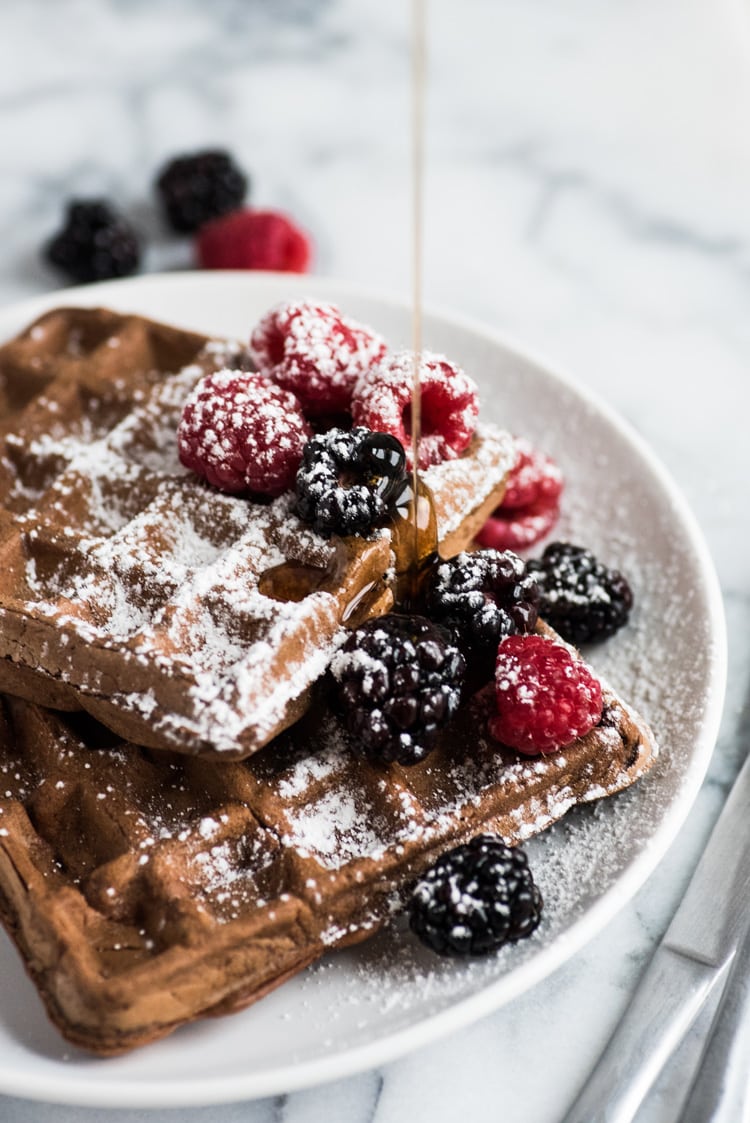 Made with a hint of cinnamon and adobo chili powder, these Chili Chocolate Waffles topped with fresh berries, powdered sugar and maple syrup are a brunch delight!