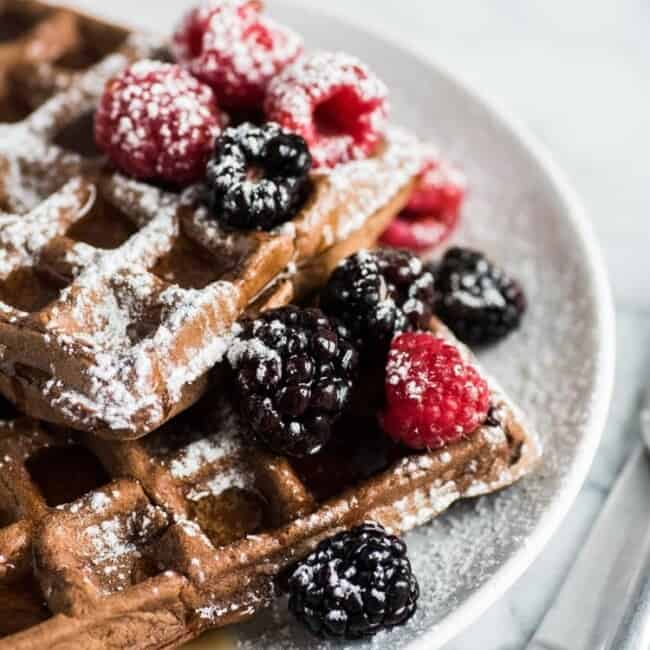 Made with a hint of cinnamon and adobo chili powder, these Chili Chocolate Waffles topped with fresh berries, powdered sugar and maple syrup are a brunch delight!