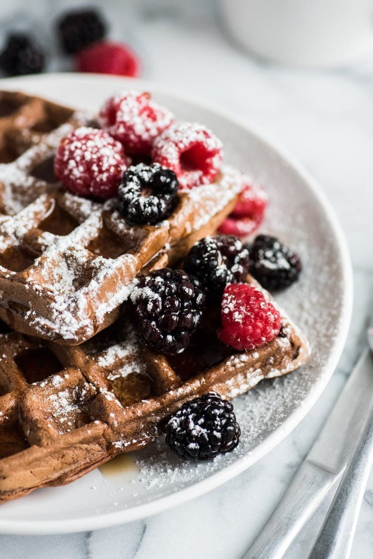 Made with a hint of cinnamon and adobo chili powder, these Chili Chocolate Waffles topped with fresh berries, powdered sugar and maple syrup are a brunch delight!