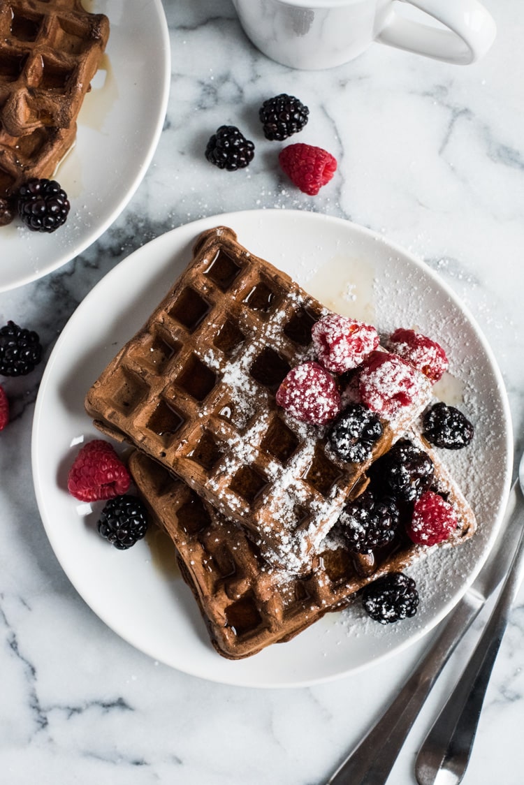 Made with a hint of cinnamon and adobo chili powder, these Chili Chocolate Waffles topped with fresh berries, powdered sugar and maple syrup are a brunch delight!