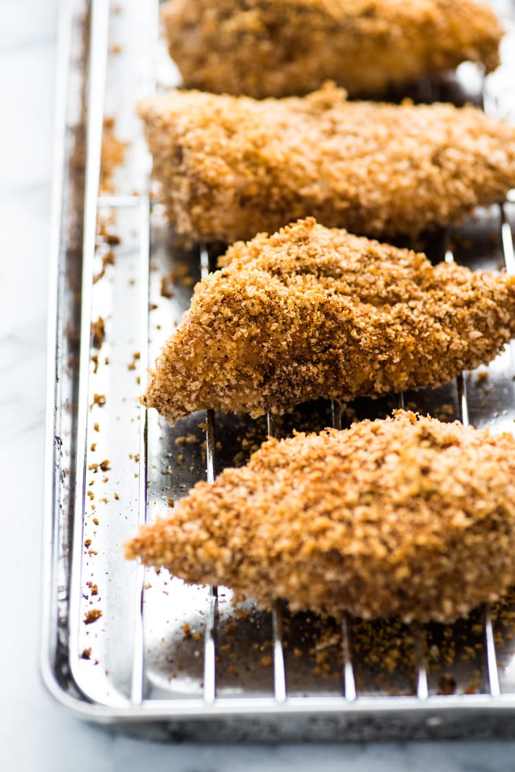 These Crispy Oven Baked Chicken Tenders seasoned with garlic, paprika and chili powder are made without the excess oil, making them a healthy meal option!