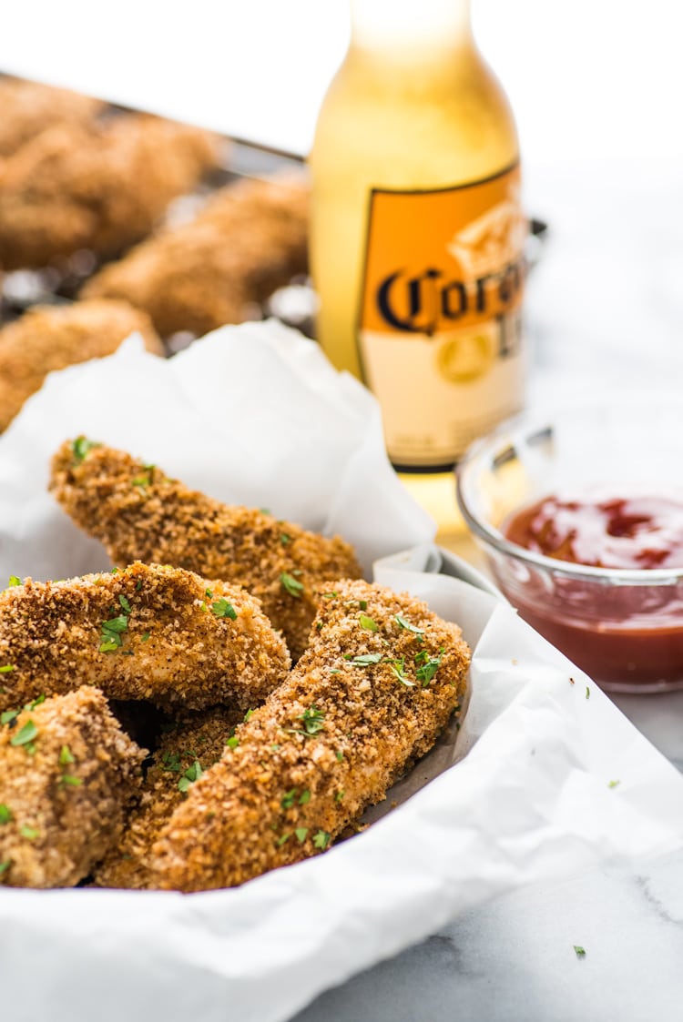 These Crispy Oven Baked Chicken Tenders seasoned with garlic, paprika and chili powder are made without the excess oil, making them a healthy meal option!