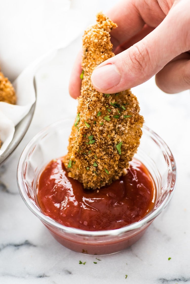 These Crispy Oven Baked Chicken Tenders seasoned with garlic, paprika and chili powder are made without the excess oil, making them a healthy meal option!