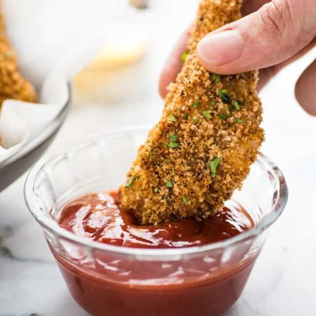 These Crispy Oven Baked Chicken Tenders seasoned with garlic, paprika and chili powder are made without the excess oil, making them a healthy meal option!
