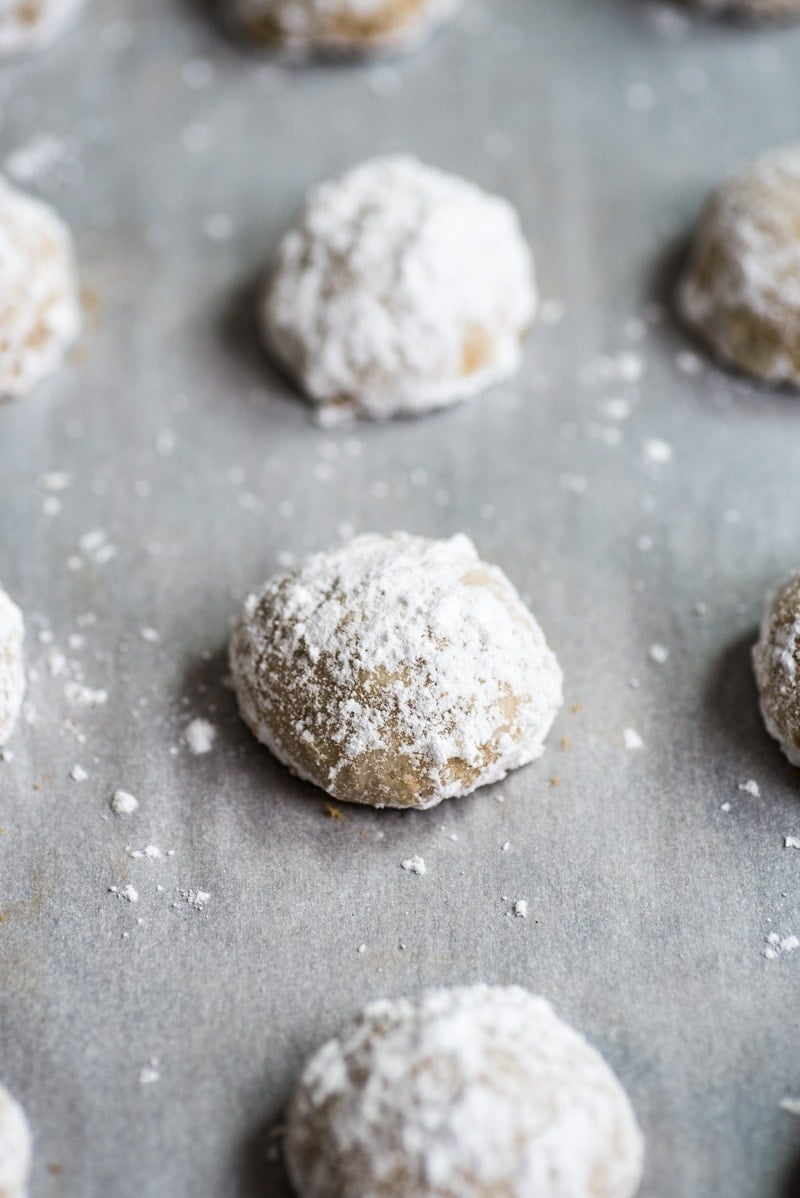 A mexican wedding cookie topped with powdered sugar.