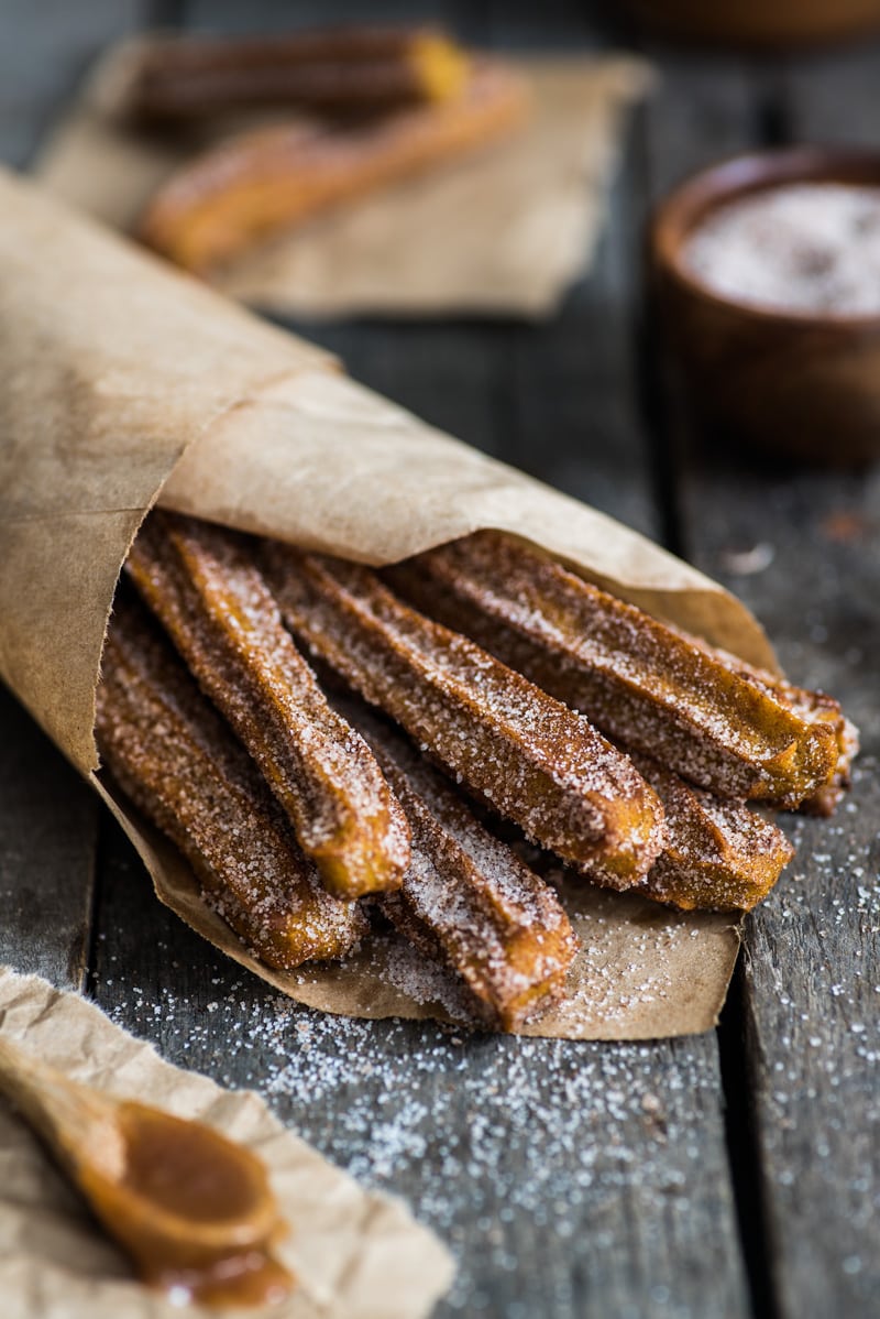 Baked Pumpkin Churros covered in cinnamon sugar are the perfect fall and winter dessert. They're baked, not fried, which means you can eat more of them!