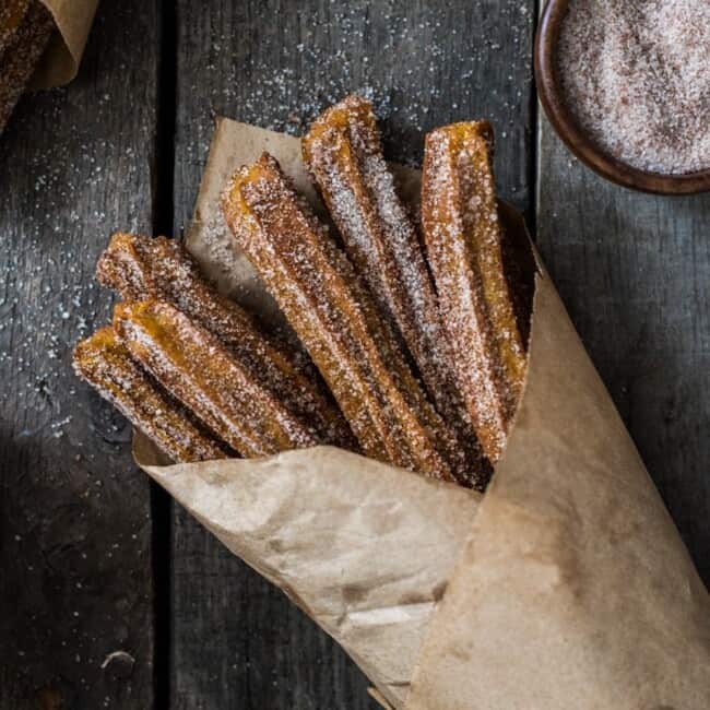 Baked Pumpkin Churros covered in cinnamon sugar are the perfect fall and winter dessert. They're baked, not fried, which means you can eat more of them!