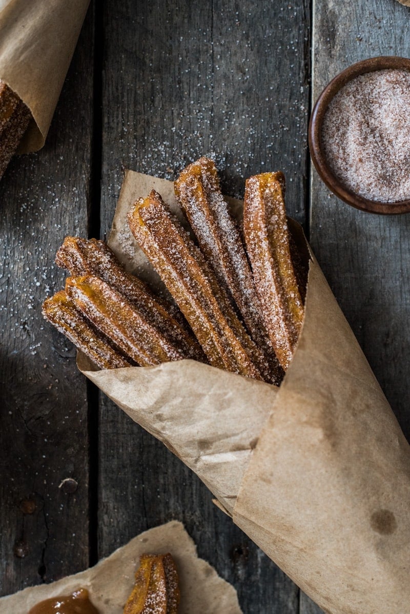 Baked Pumpkin Churros covered in cinnamon sugar are the perfect fall and winter dessert. They're baked, not fried, which means you can eat more of them!
