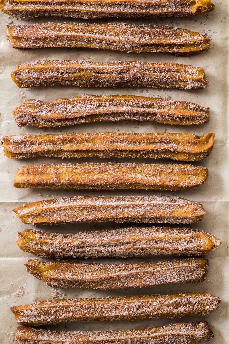 Baked Pumpkin Churros covered in cinnamon sugar are the perfect fall and winter dessert. They're baked, not fried, which means you can eat more of them!