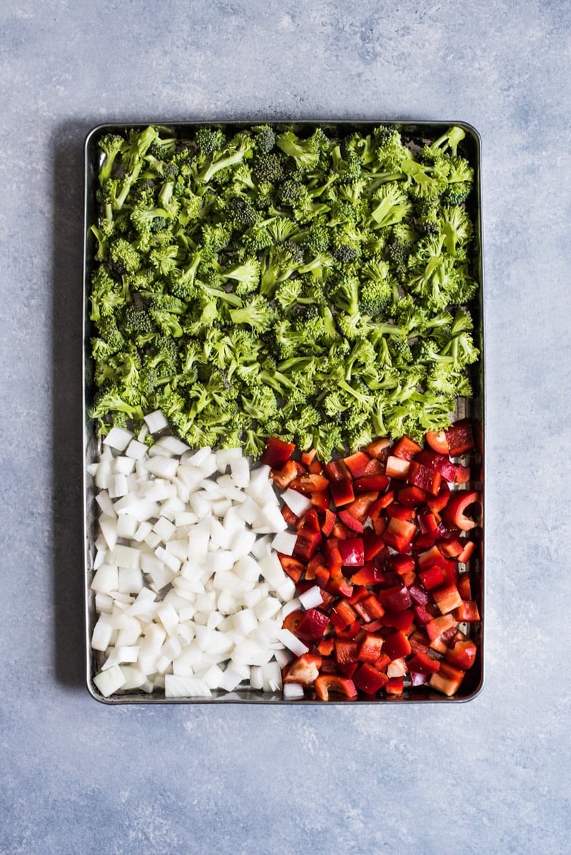 Broccoli, onions and bell peppers on a baking sheet