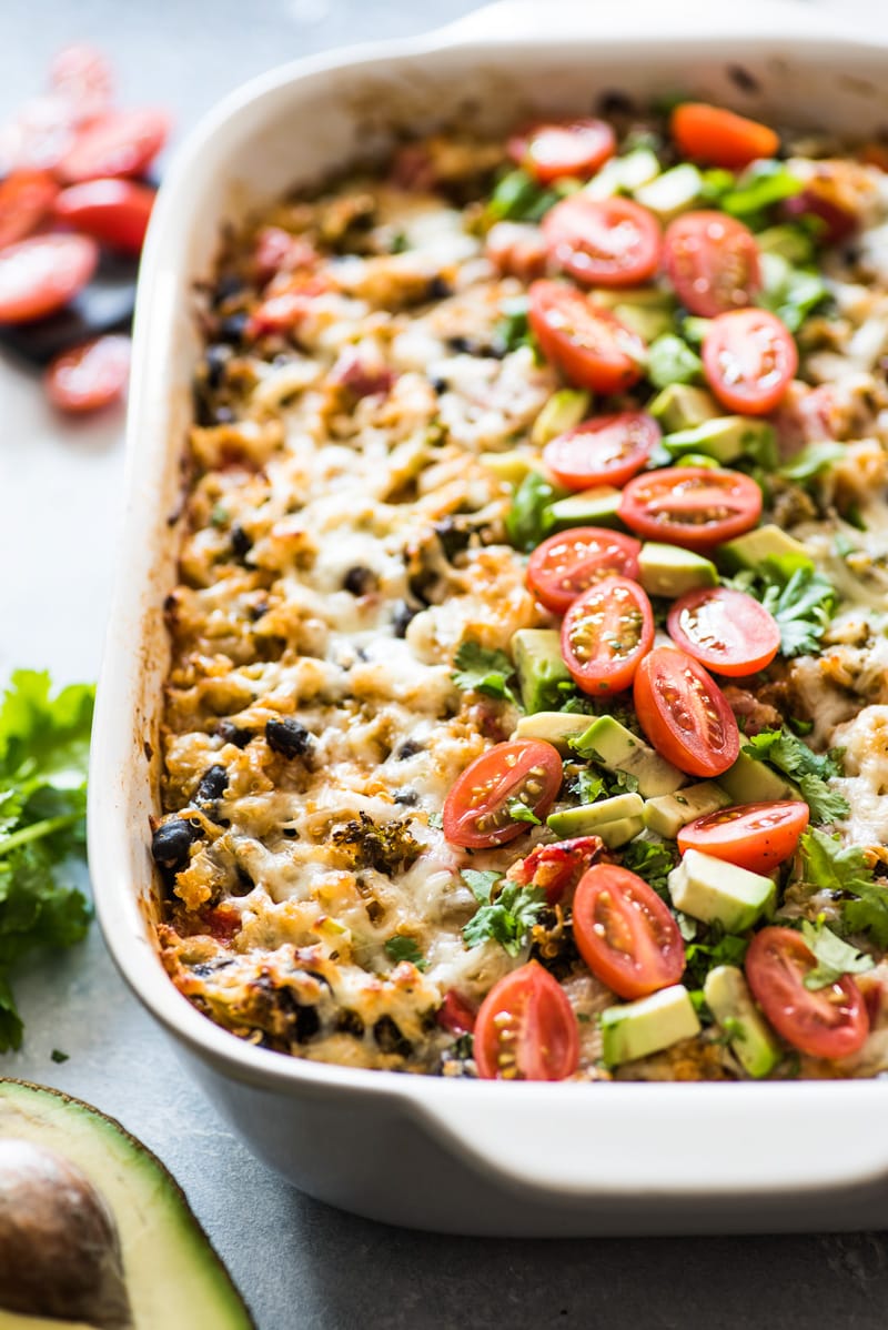 A Quinoa enchilada casserole in a baking dish ready to be eaten.