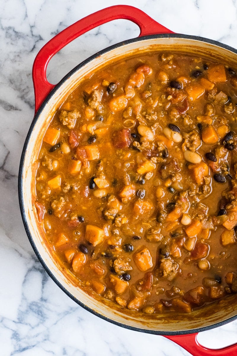 Turkey pumpkin chili in a red dutch oven.